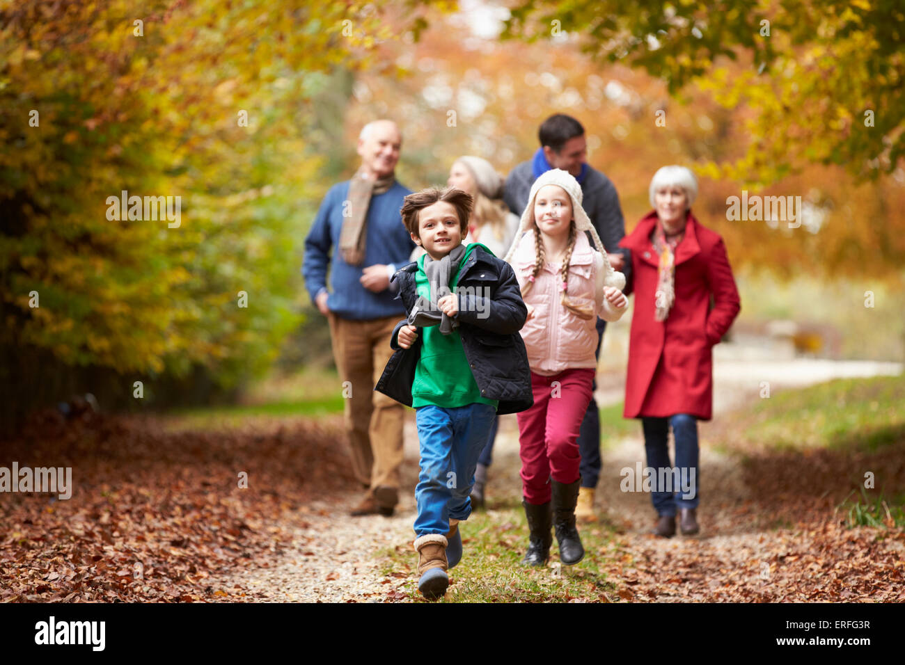 Multl Generation Family Walking Along Autumn Path Stock Photo - Alamy