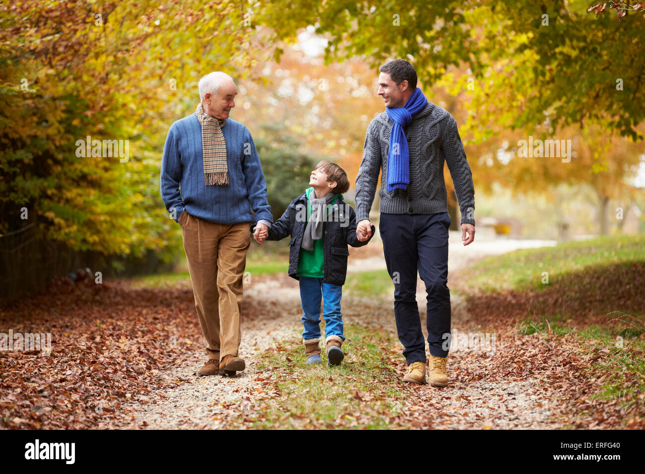Male Multl Generation Family Walking Along Autumn Path Stock Photo - Alamy