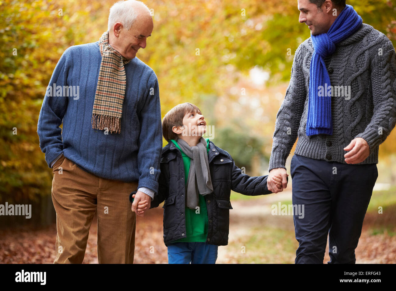 Male Multl Generation Family Walking Along Autumn Path Stock Photo - Alamy