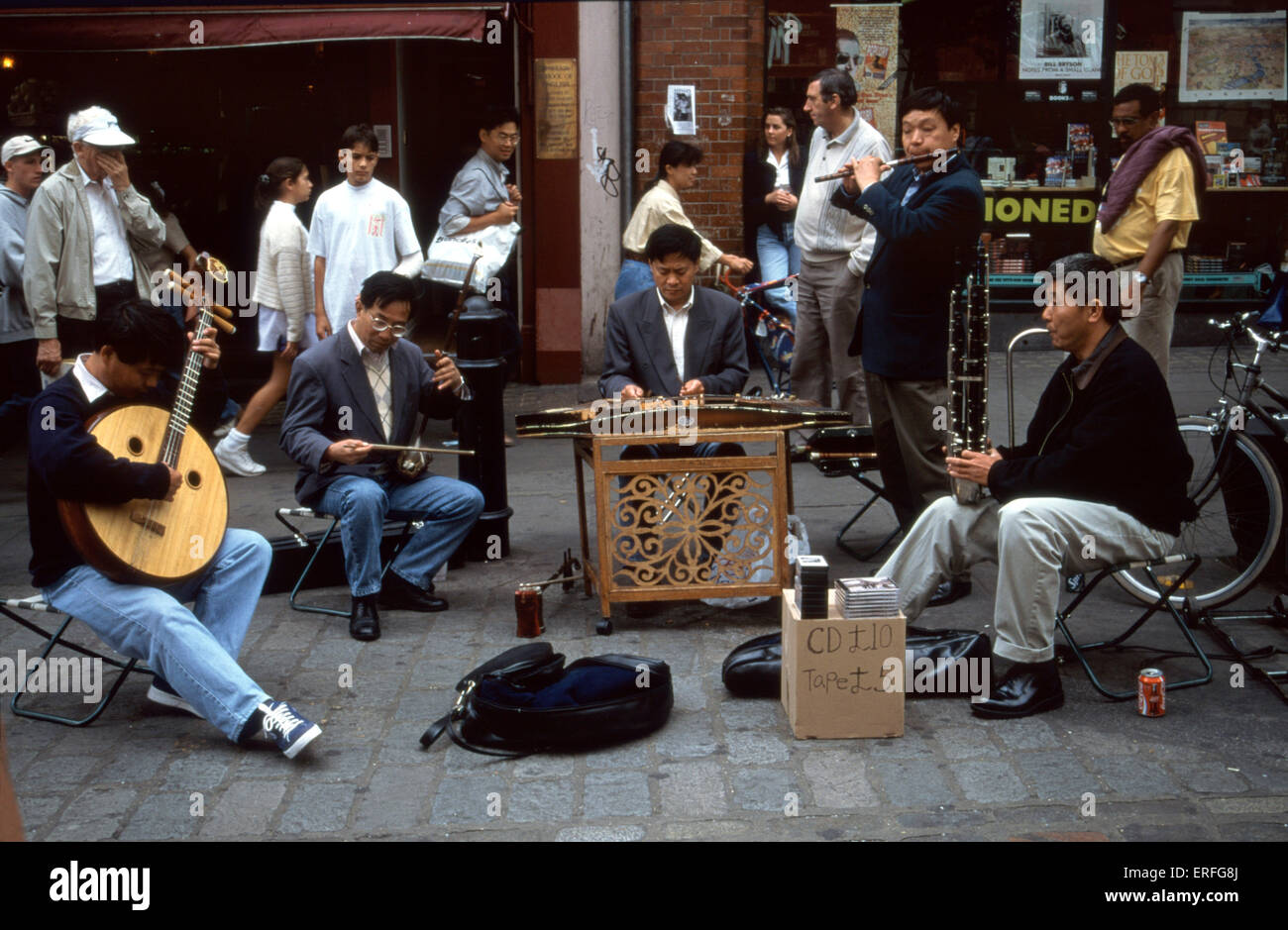 Chinese ensemble - musicians on the street, playing various Chinese instruments: (l-r:) Yueh-Chin (moon guitar); Erhu; Yangqin Stock Photo