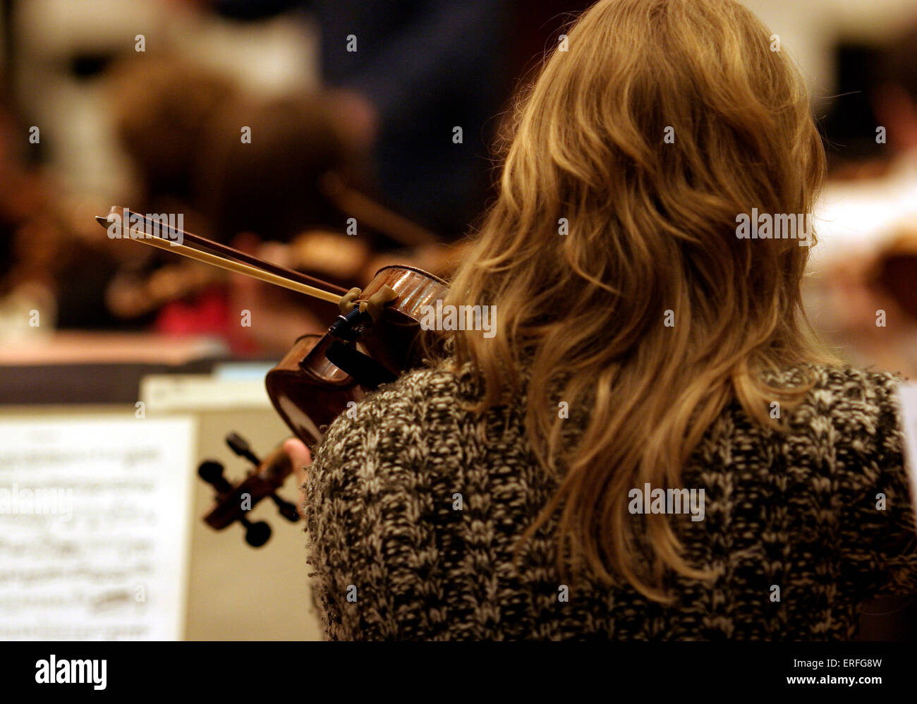 Violinist - playing in rehearsal - view from behind Stock Photo
