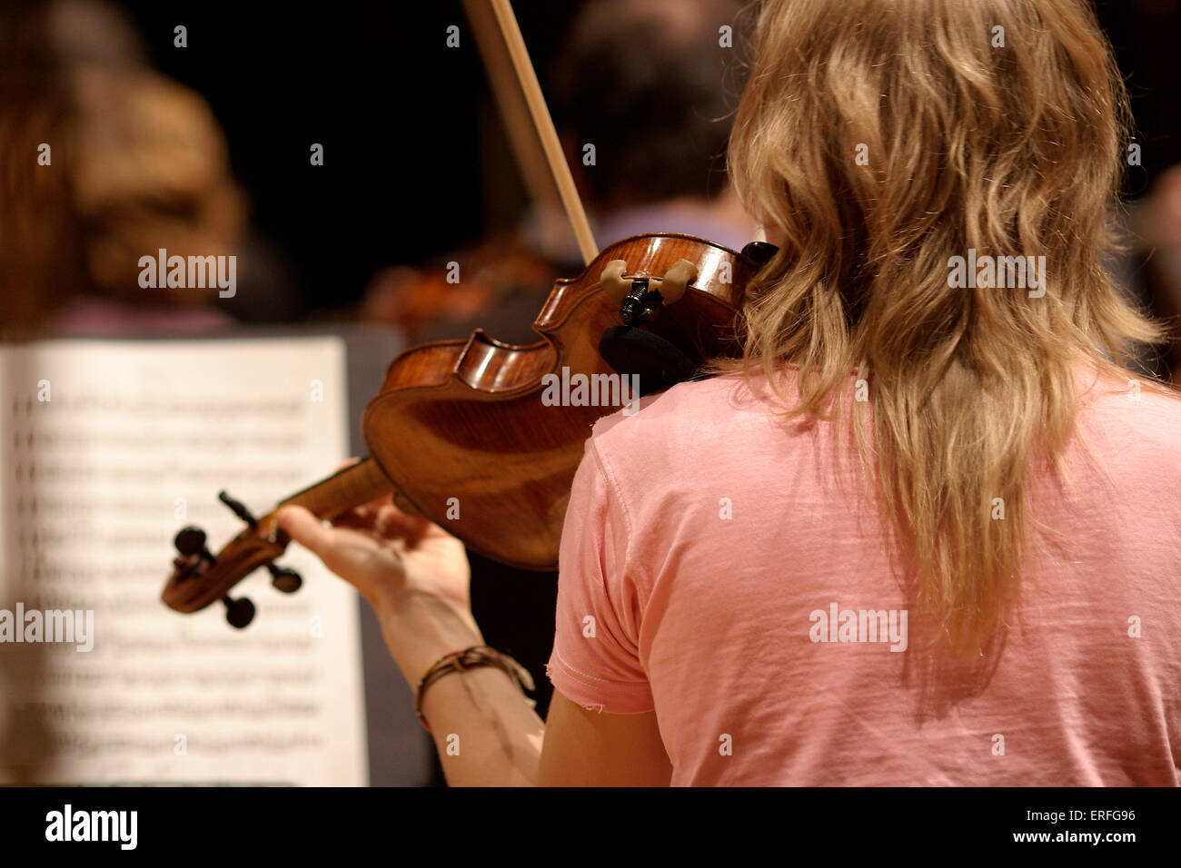 Violinist - playing in rehearsal - view from behind Stock Photo