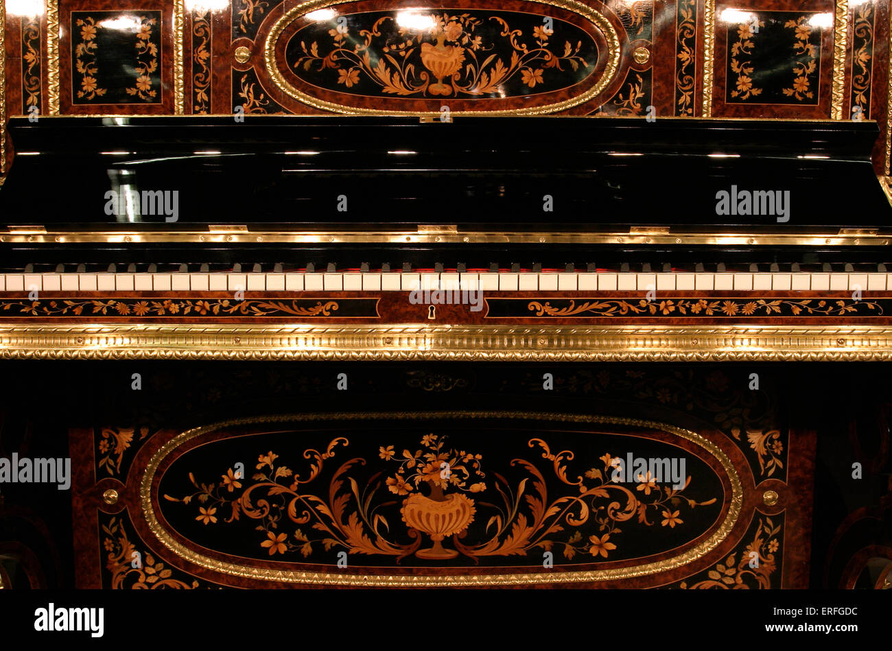 Upright piano, highly decorated using Burr wood and inlays. Stock Photo