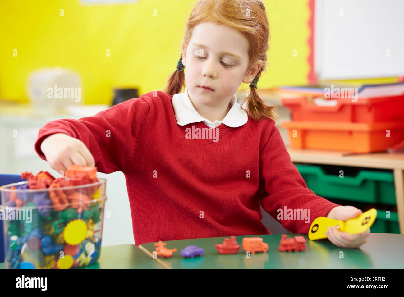 Female Pupil Practising Maths At Desk Stock Photo
