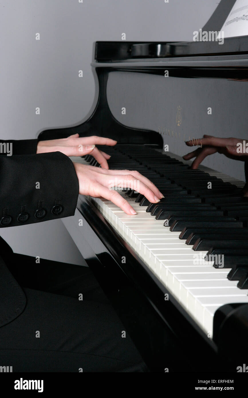 Piano - close up of a player's hands on the keyboard of a grand piano.   Amanda Buckley Stock Photo