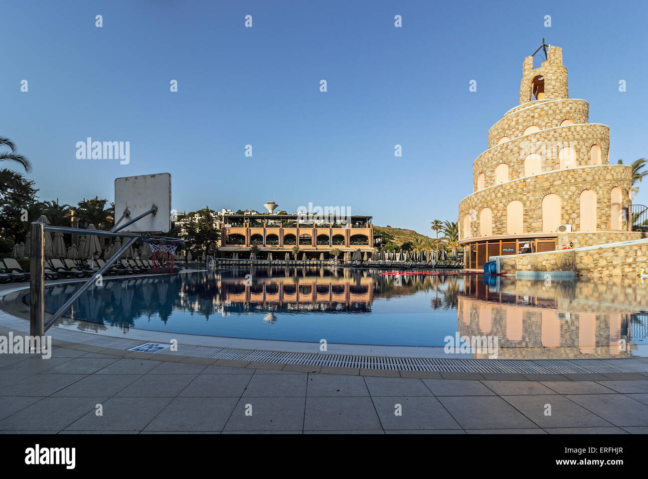 Pool, waterslide and restaurant at the Bodrum Imperial hotel at dusk in the Turgutreis region of Turkey. Stock Photo