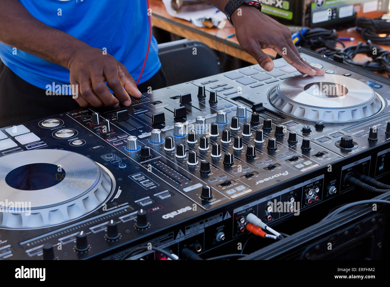 An African-American DJ playing music at an outdoor event - USA Stock Photo