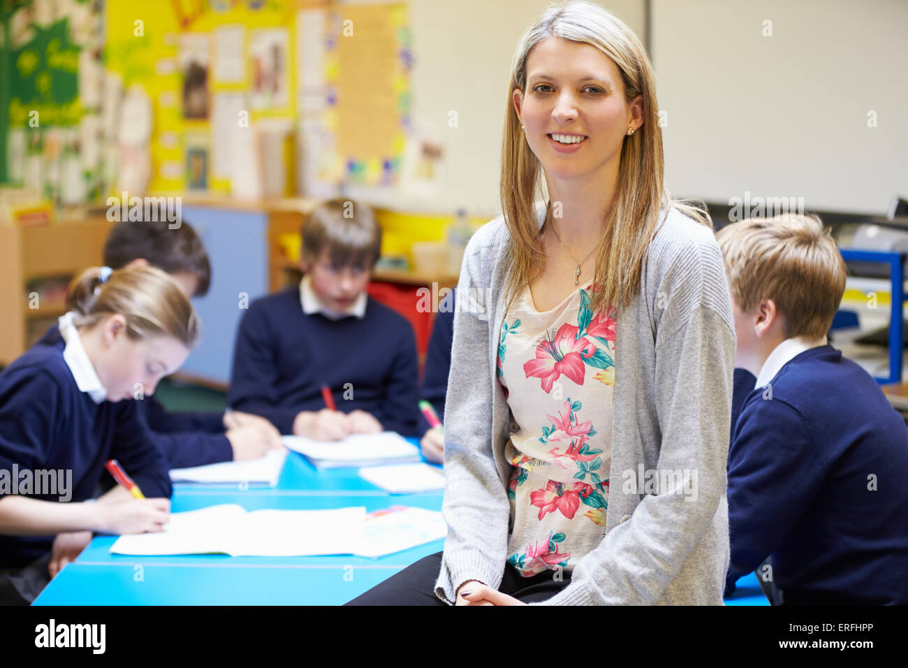 Portrait Of Teacher In Classroom With Pupils Stock Photo - Alamy