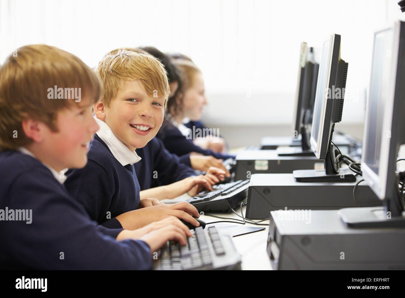 Line Of Children In School Computer Class Stock Photo