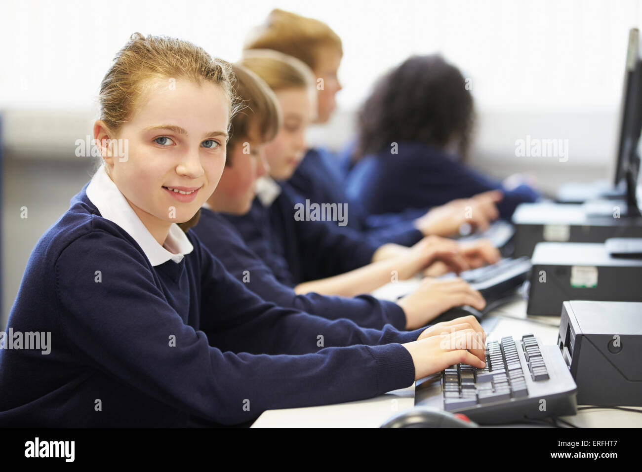 Line Of Children In School Computer Class Stock Photo