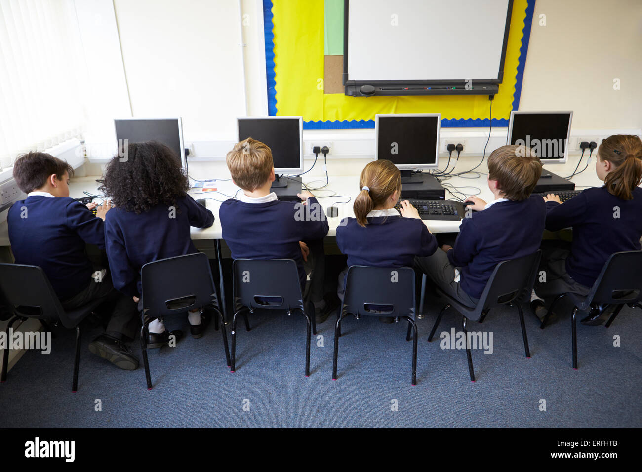 Line Of Children In School Computer Class Stock Photo