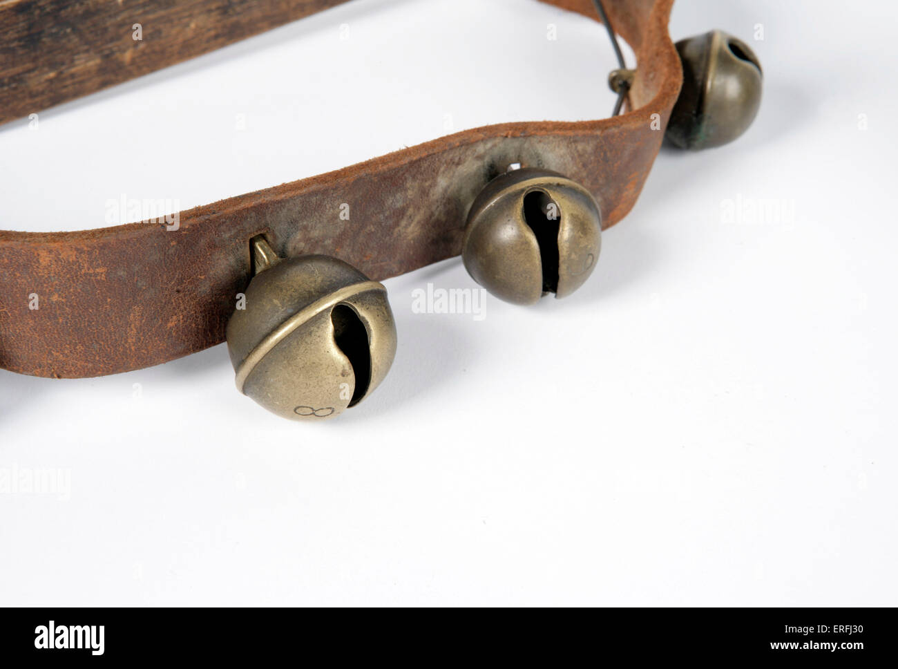 Sleigh bells on a leather strap. White background Stock Photo Alamy
