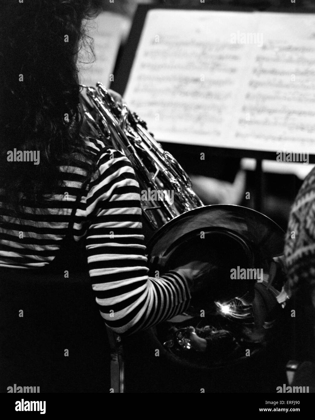 French horn being played by female musician. Brass instrument Stock