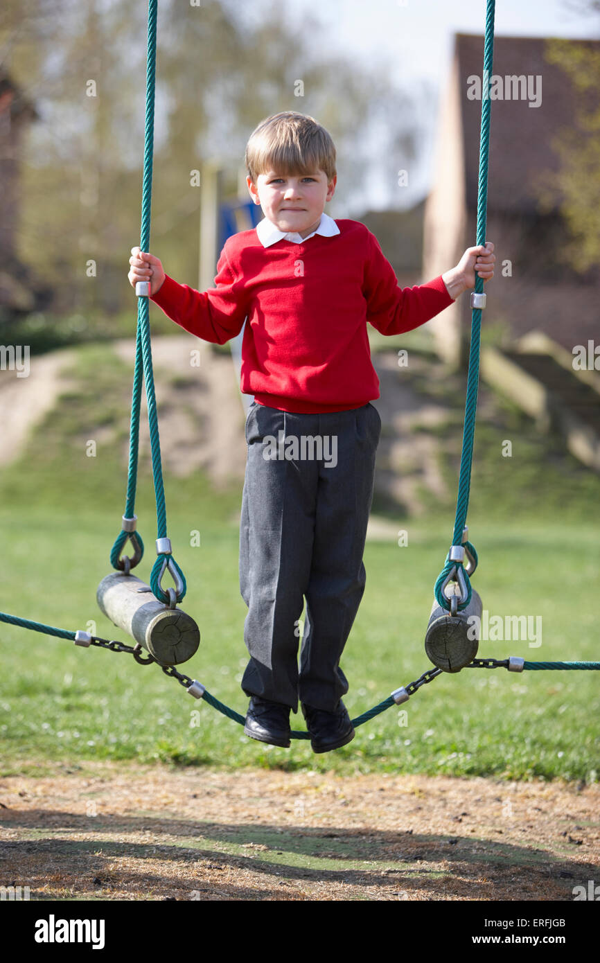 Male Elementary School Pupil On Climbing Equipment Stock Photo - Alamy