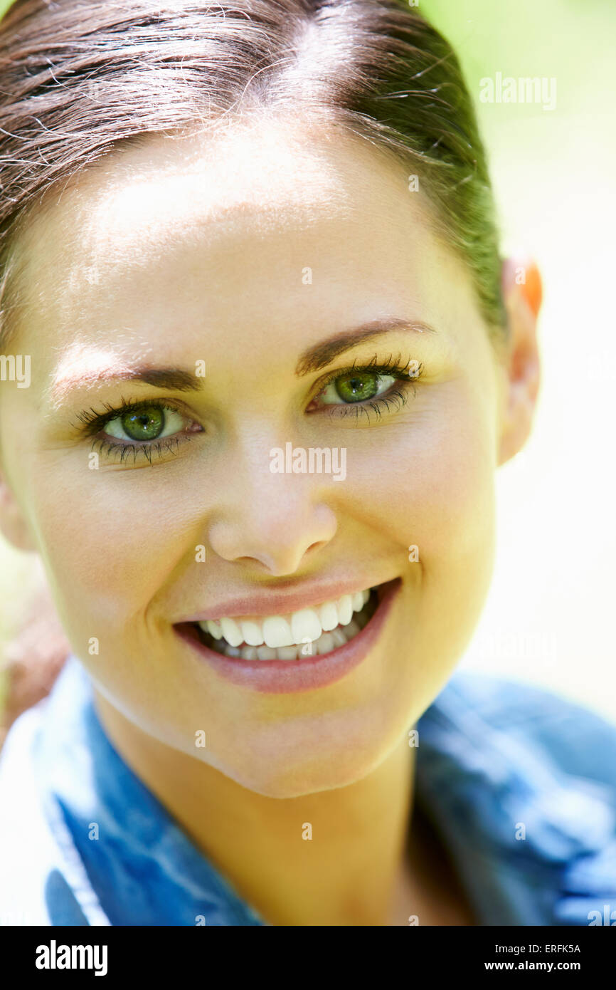 Portrait Of Young Woman Sitting In Field Stock Photo - Alamy