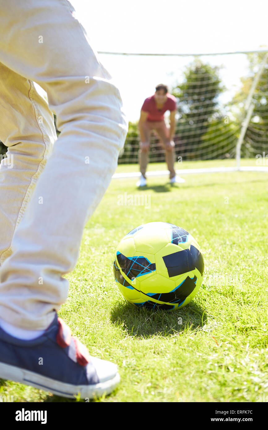 Father And Son Playing Football Together Stock Photo