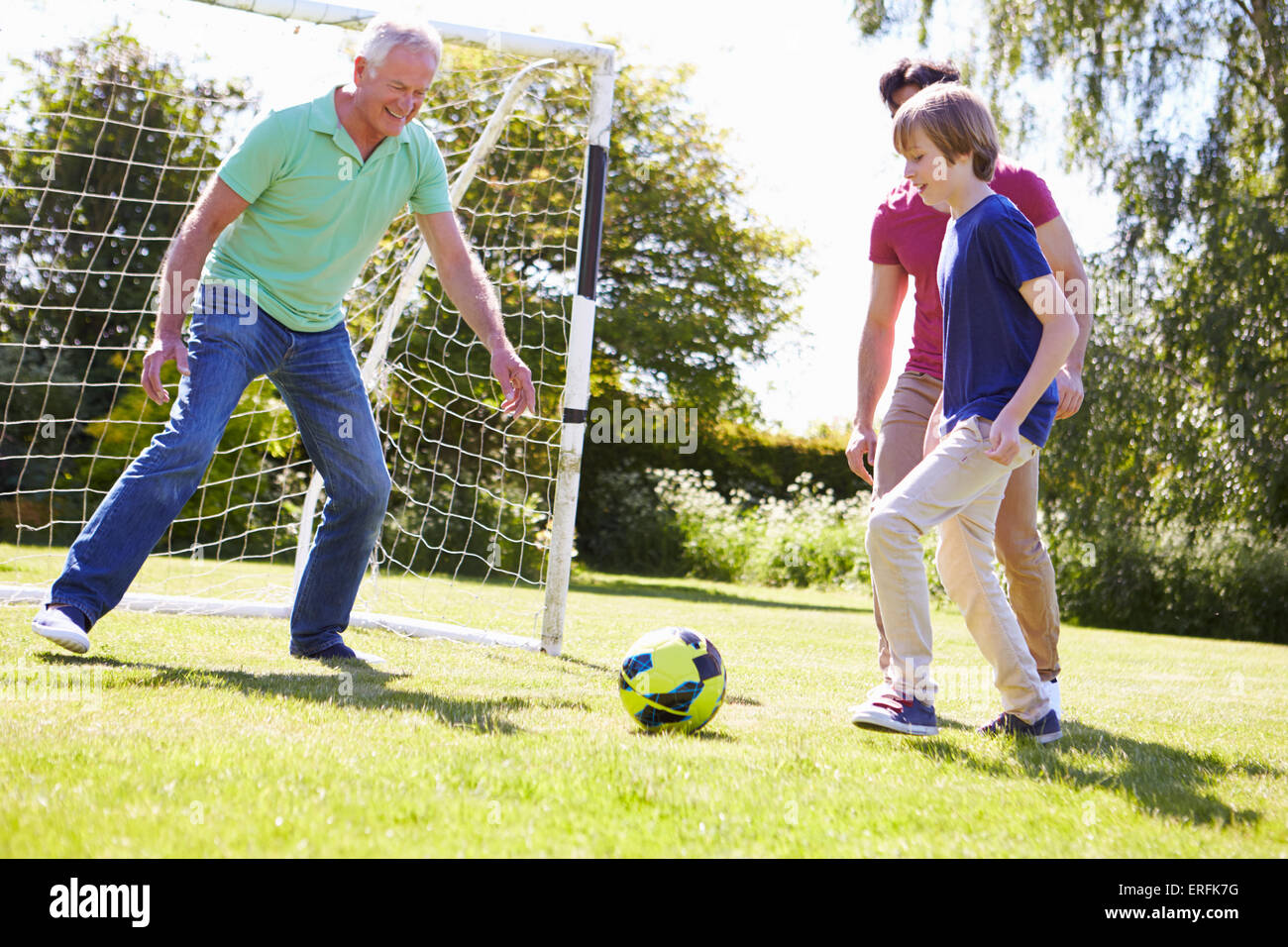 Male Three Generation Family Playing Football Together Stock Photo - Alamy