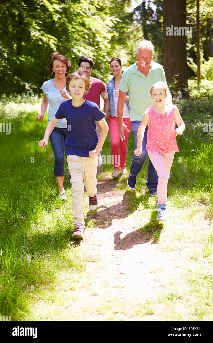 Multi Generation Family Running Through Summer Countryside Stock Photo