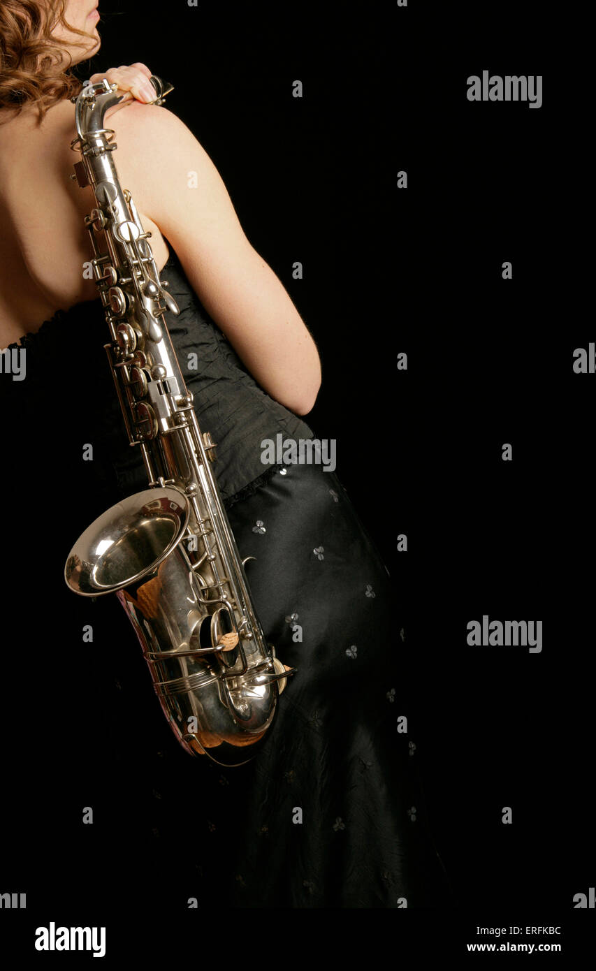 Alto saxophone with female player or singer holding the instrument