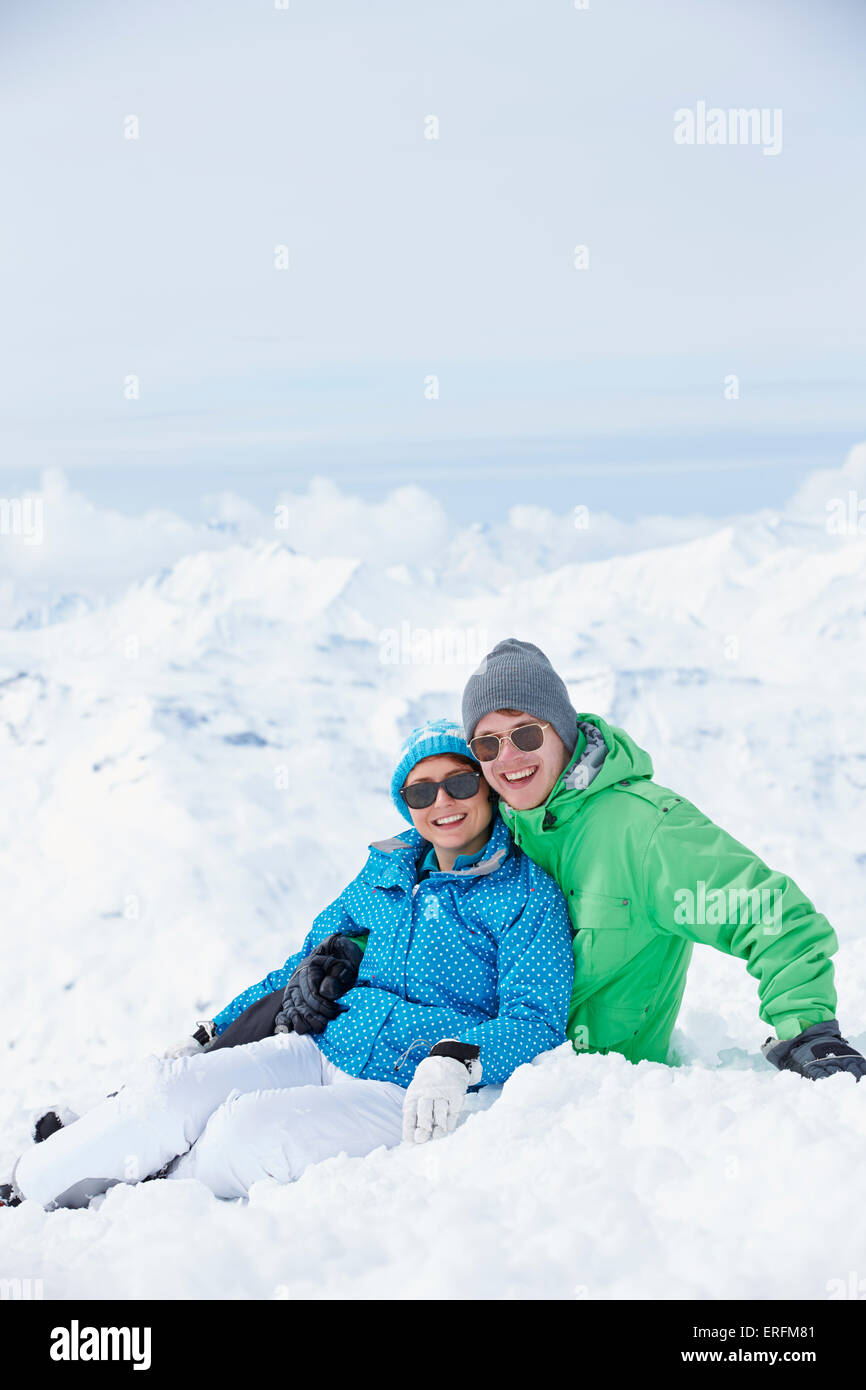 Couple Having Fun On Ski Holiday In Mountains Stock Photo