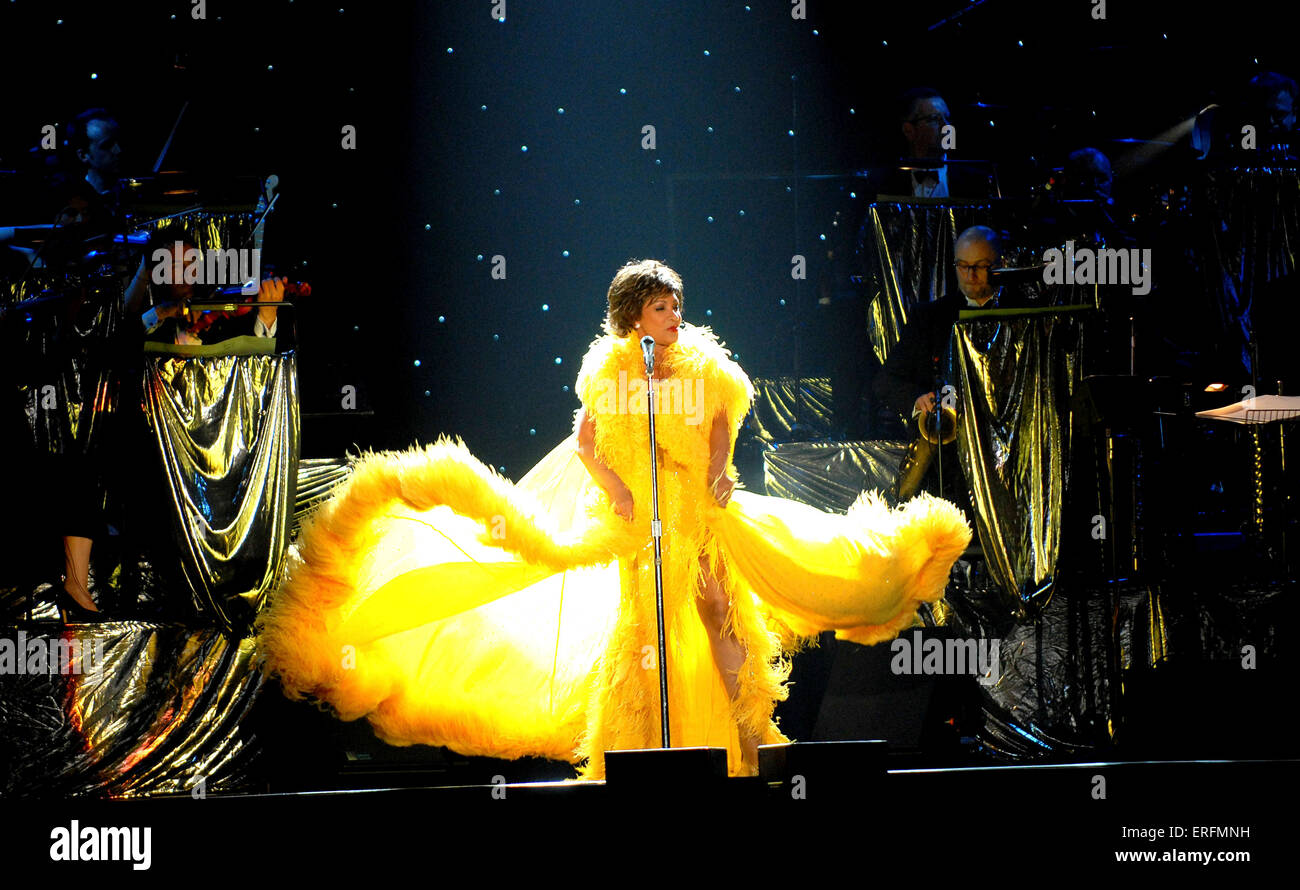 Shirley Bassey - Welsh singer performing at the Wembley Arena, London, UK, 9 June 2006. B. 8 January 1937, Dame Veronica Shirley Bassey. Wearing yellow dress. Gold decorations. Orchestra in the background. James Bond connection. Stock Photo