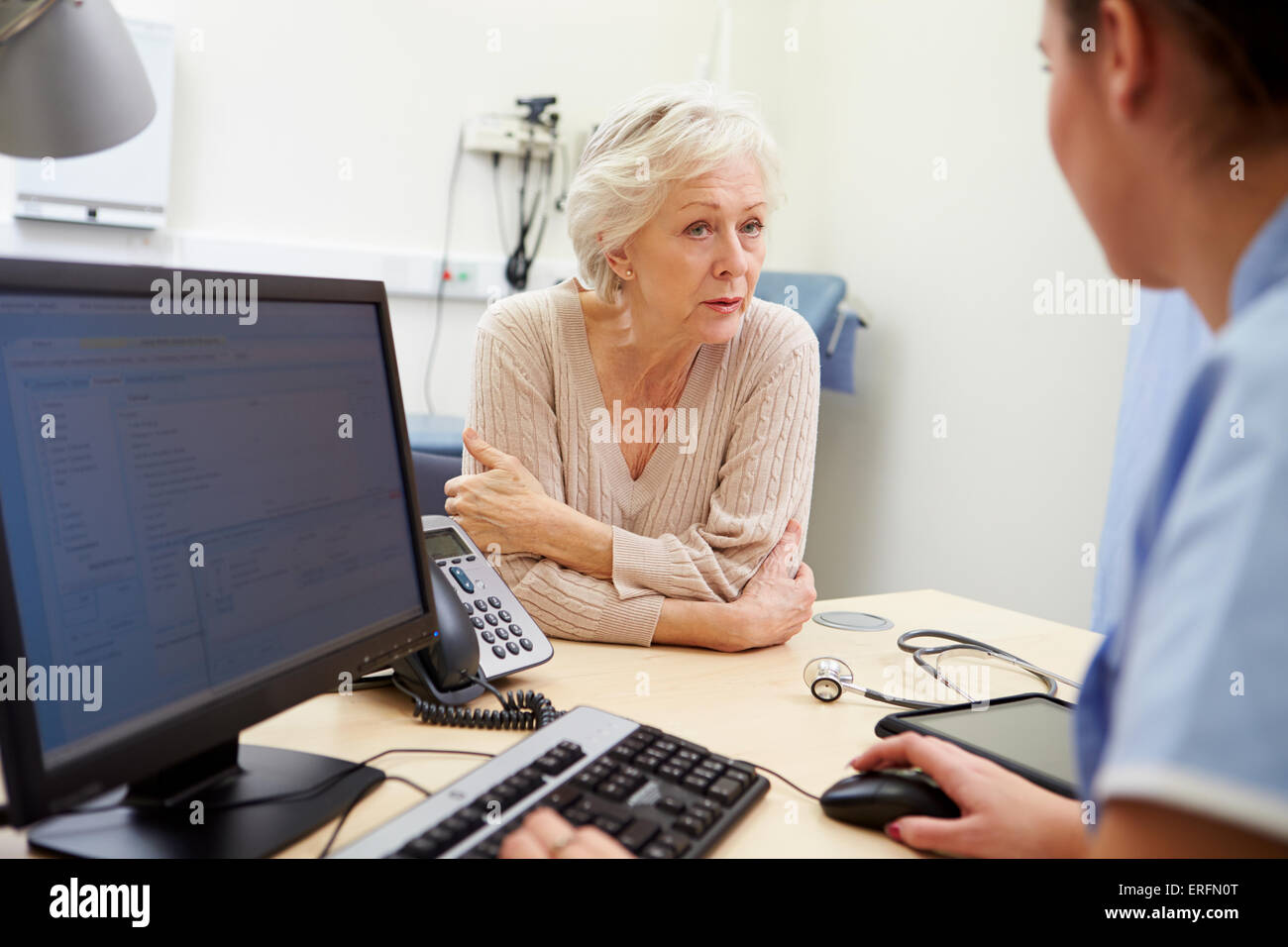 Senior Female Patient Has Appointment With Nurse Stock Photo