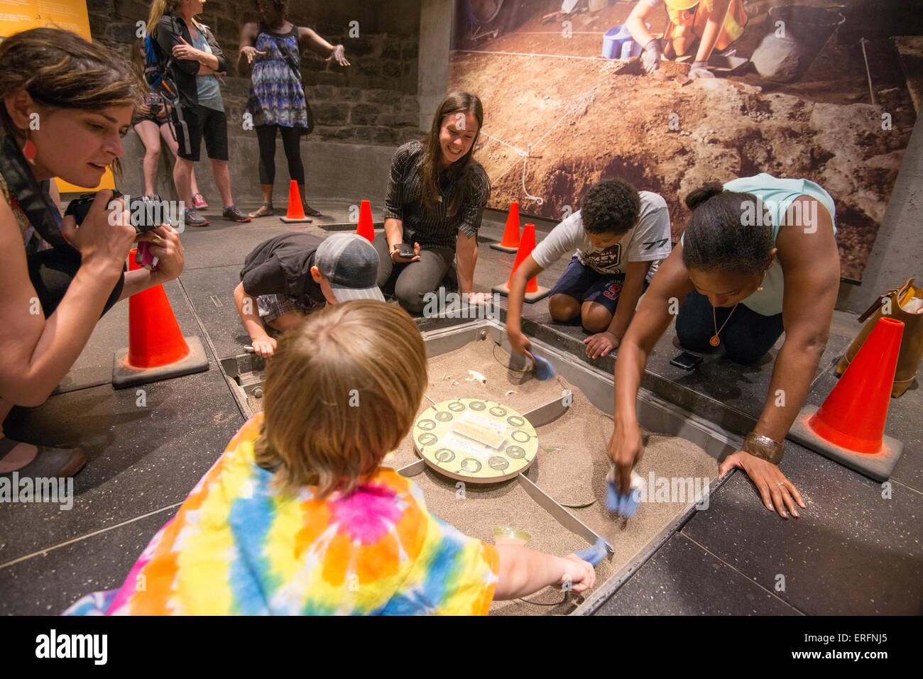 Family Fun in Montreal, Quebec, Canada. Montreal Museum of Archaeology and History. Children digging through interactive exhibit Stock Photo