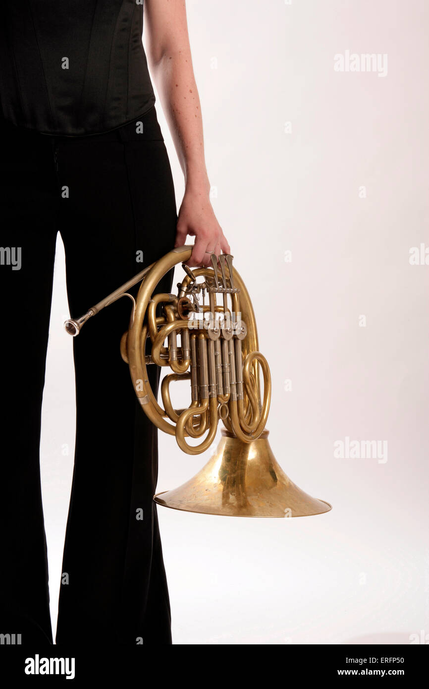 French Horn player holding her horn Stock Photo Alamy