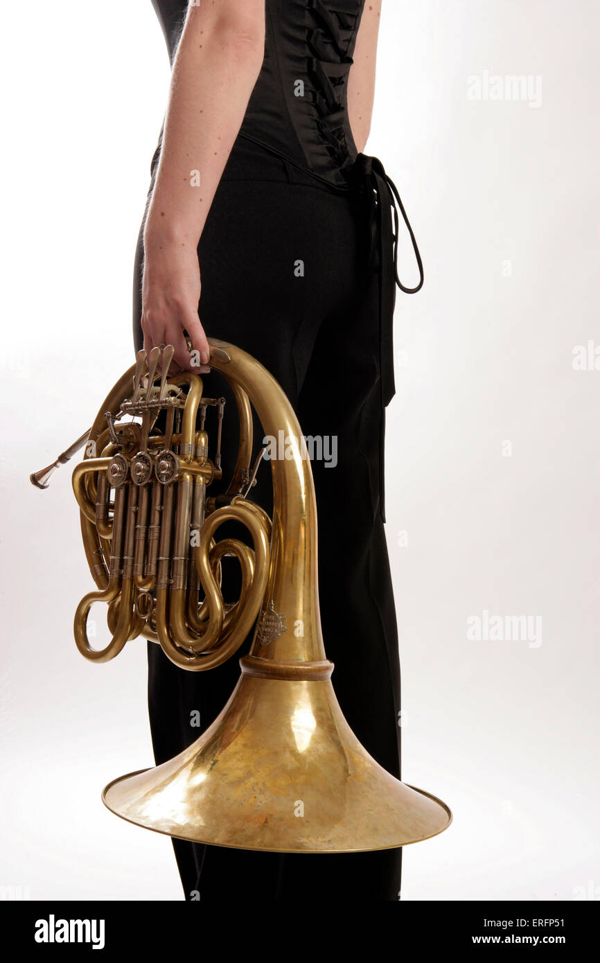 French Horn player holding her horn Stock Photo Alamy