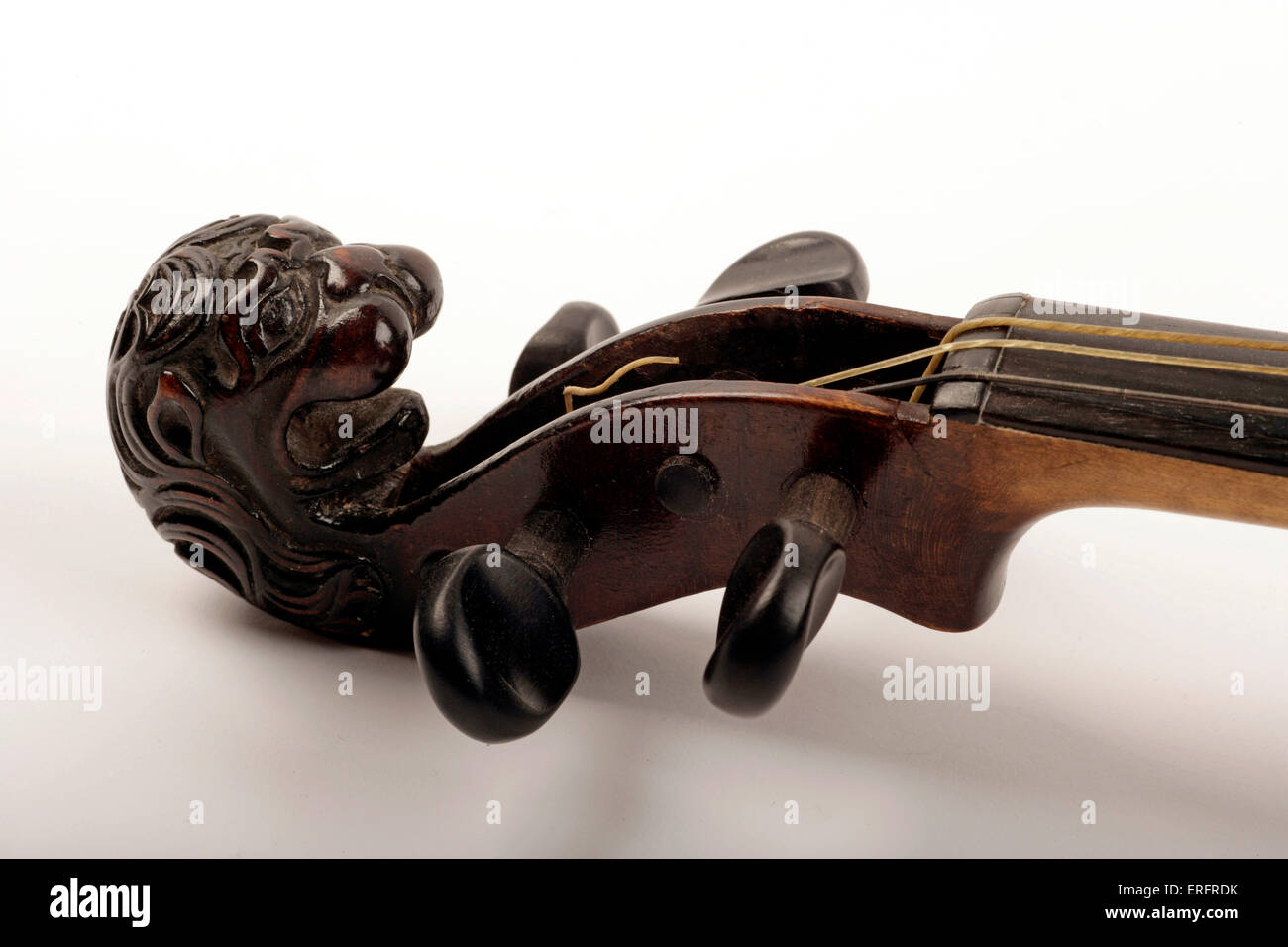 Violin scroll carved in the shape of a lions head, with gut strings