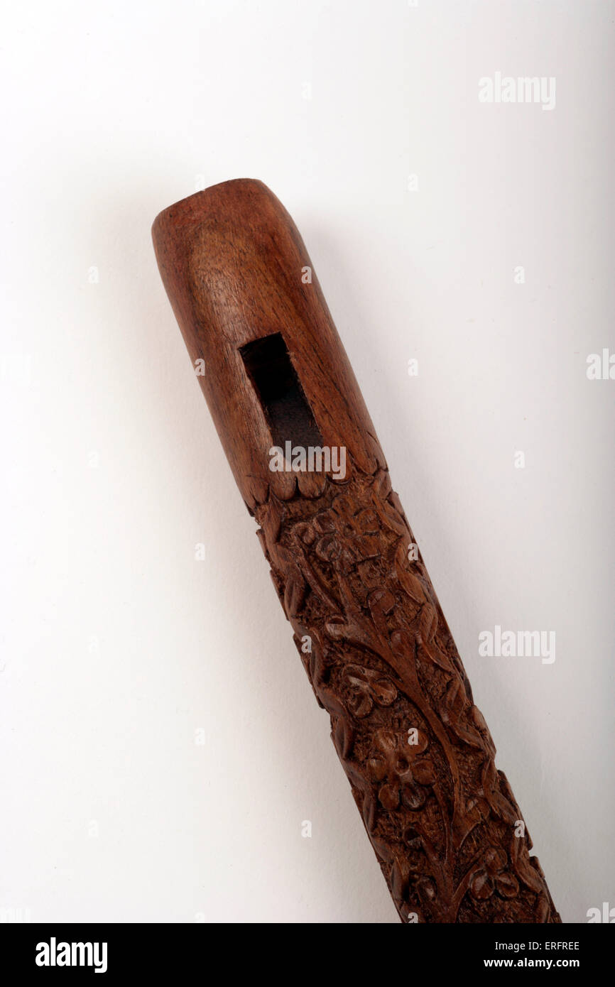 Carved wooden Arabic flute made of rosewood. Detail of mouthpiece and