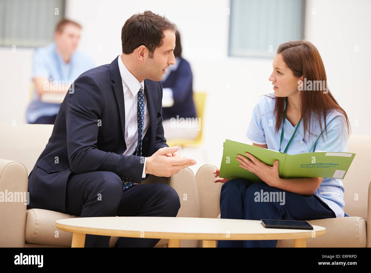 Businessman Discussing Test Results With Nurse Stock Photo