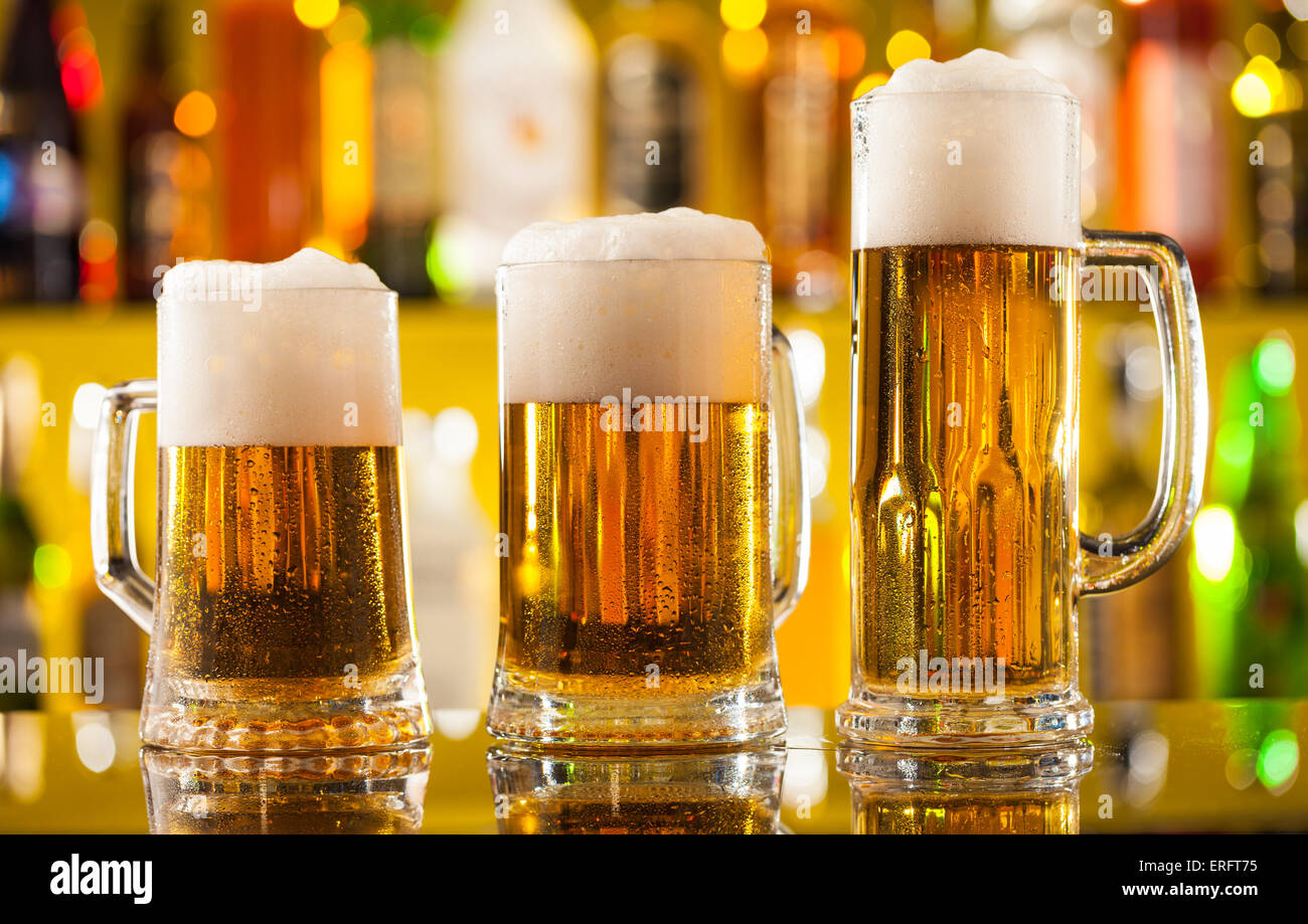 Jugs of beer placed on bar counter with copyspace Stock Photo