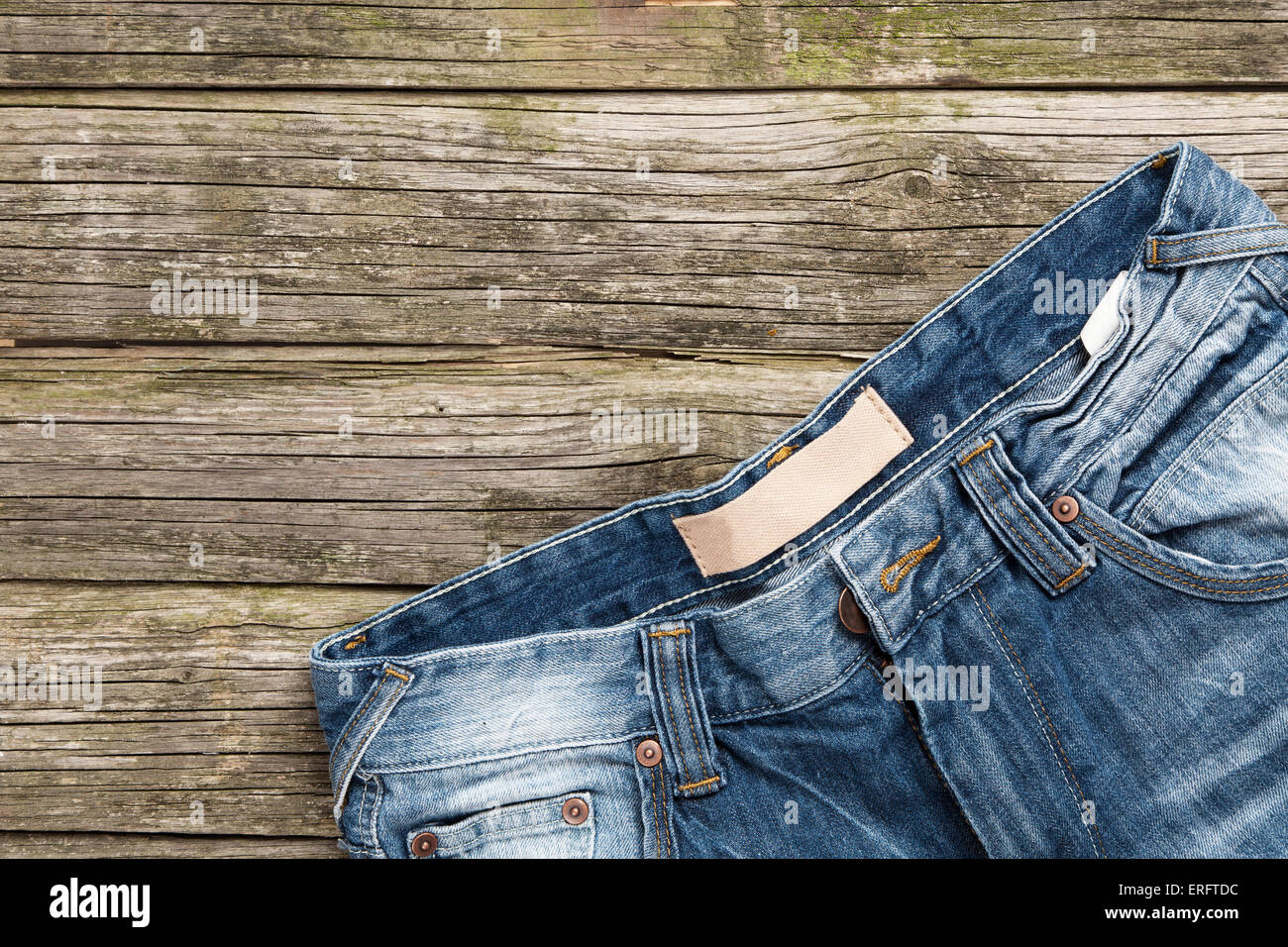 Jeans on wooden background Stock Photo