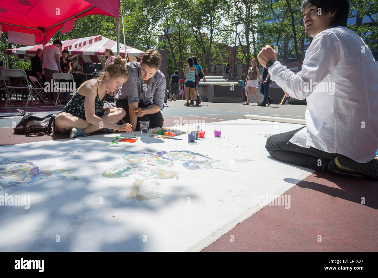 Volunteers paint their portion of a banner in Sara Delano Roosevelt Park in New York on Saturday, May 30, 2015. (© Richard B. Levine) Stock Photo