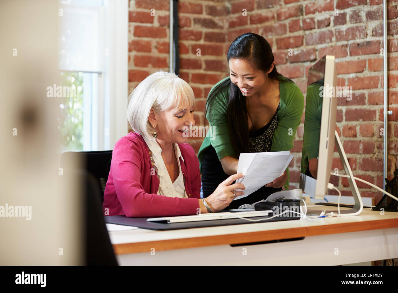 Two Businesswomen Meeting In Creative Office Stock Photo - Alamy