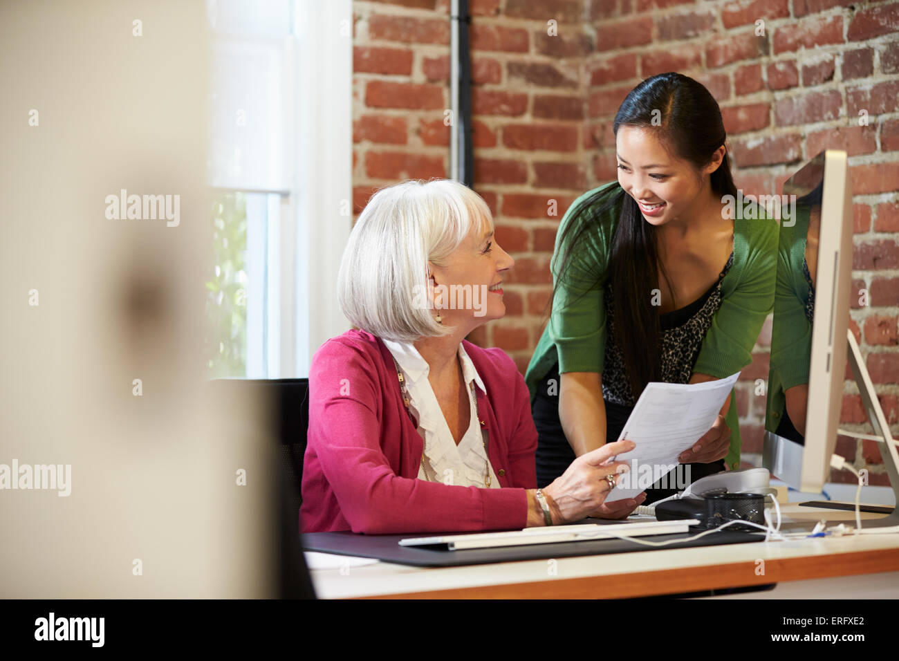 Two Businesswomen Meeting In Creative Office Stock Photo - Alamy