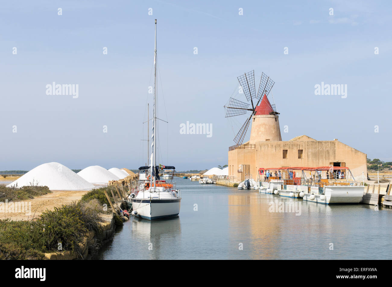 16th century windmill at the Ettore and Infersa Saltworks, Stagnone Lagoon salt pan area near Trapani, Marsala, Sicily, Italy Stock Photo