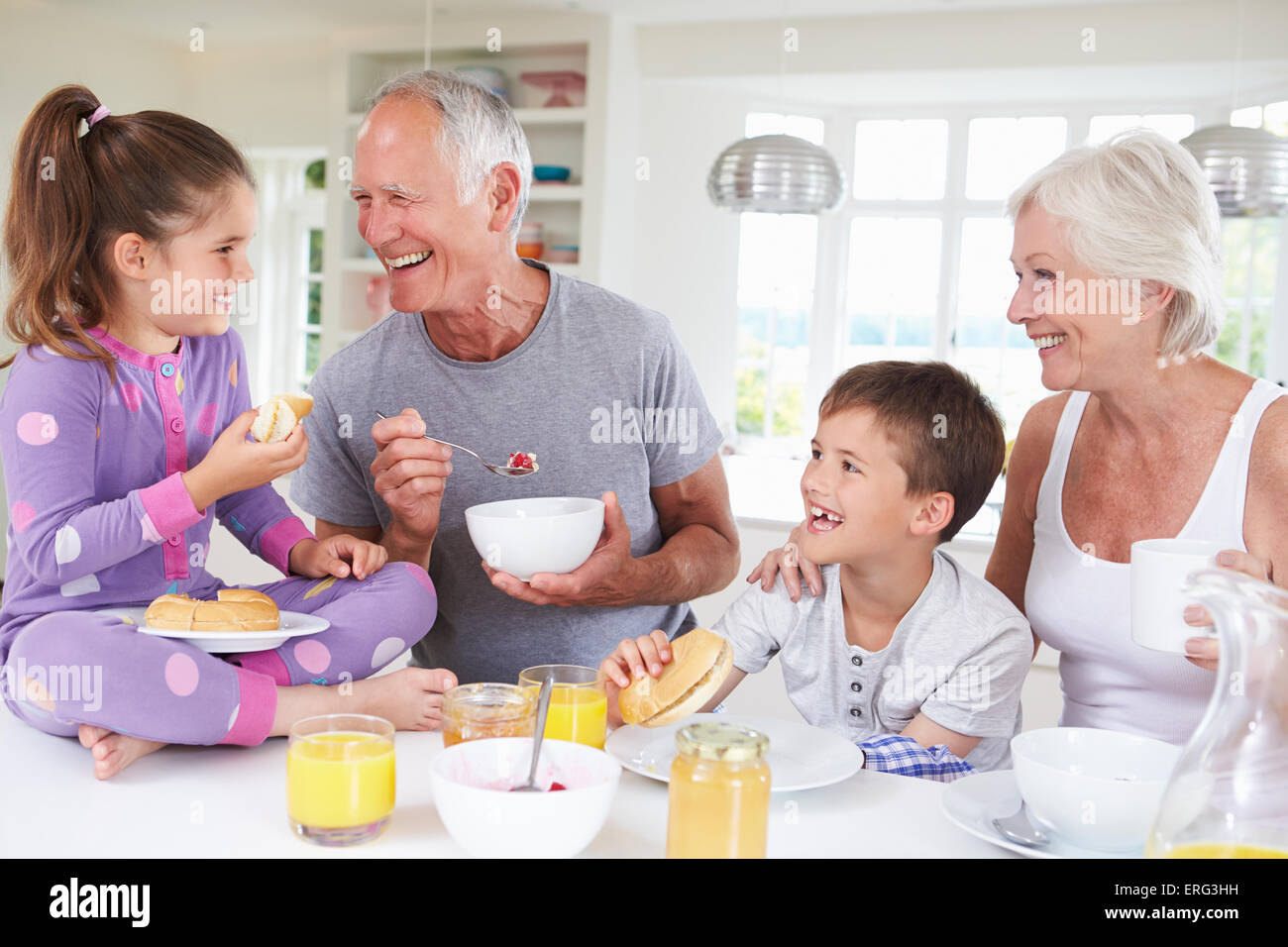 Grandparents With Grandchildren Eating Breakfast In Kitchen Stock Photo ...