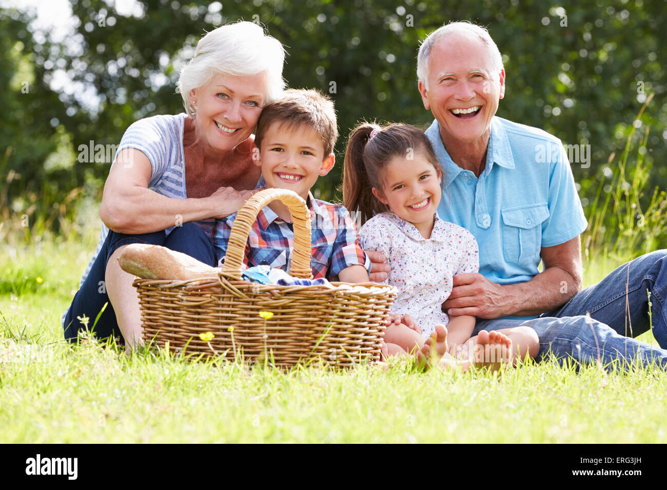 Grandparents With Grandchildren Enjoying Picnic Together Stock Photo