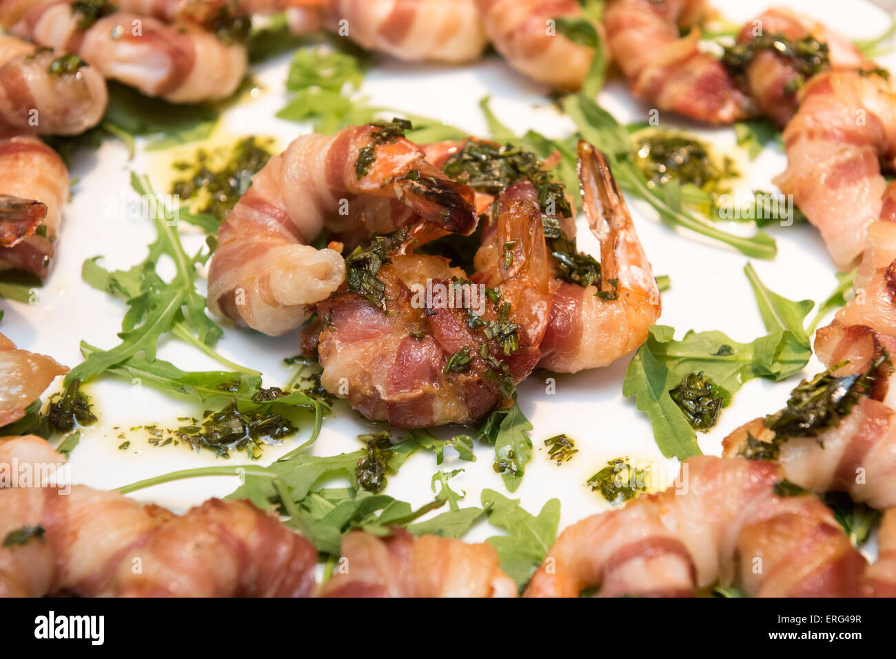 Seasoned prawns wrapped in bacon served as a starter appetiser. Stock Photo