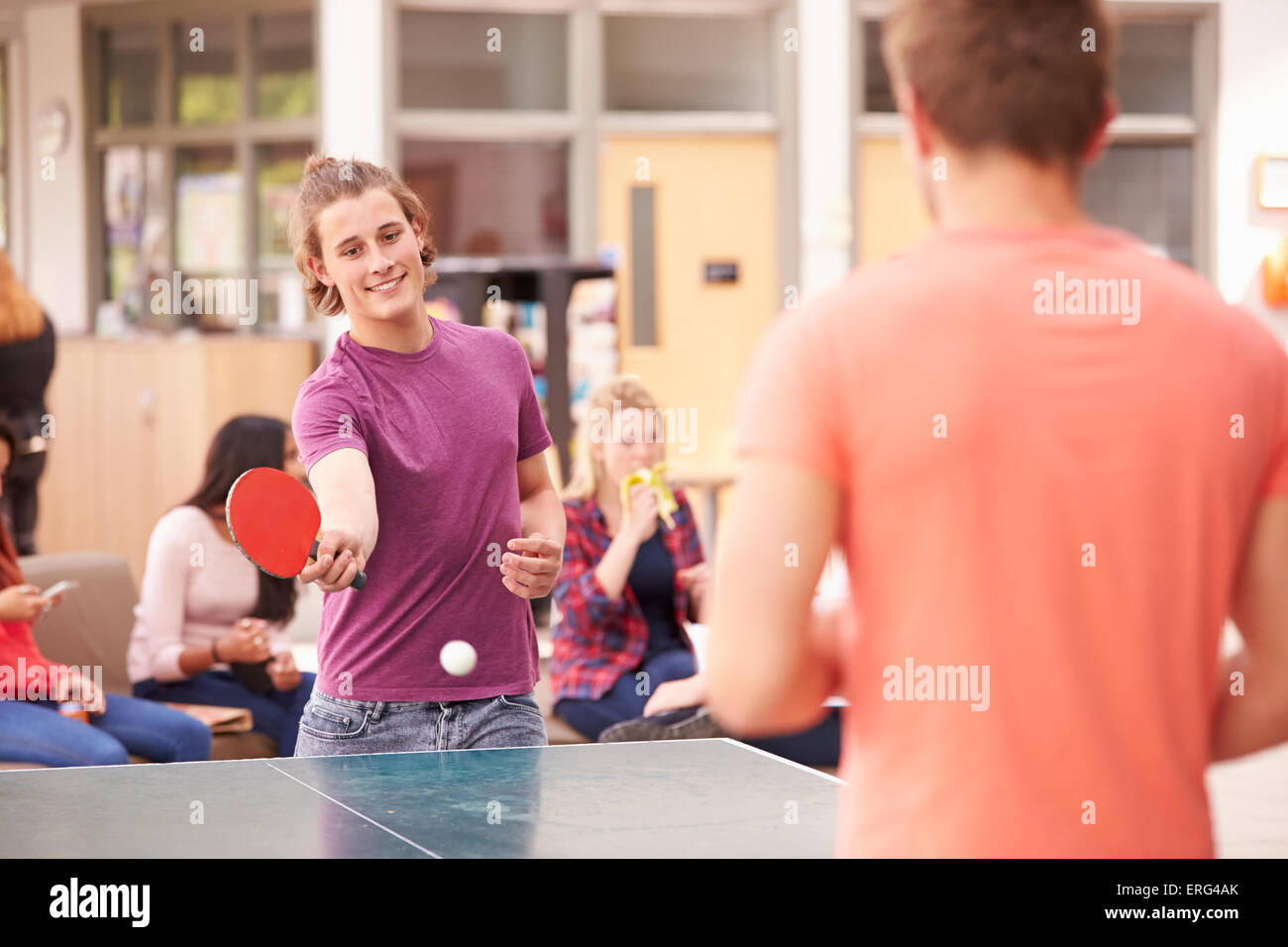 College Students Relaxing And Playing Table Tennis Stock Photo