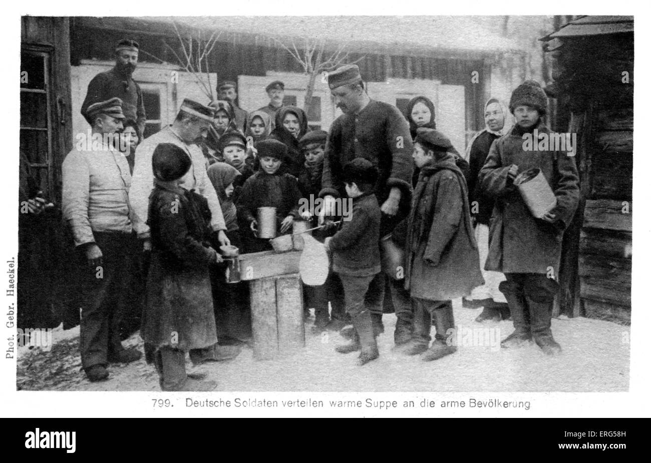 German Occupation on the Eastern Front  in World War I. Taken from photograph, shows German soldiers distributing food among Stock Photo