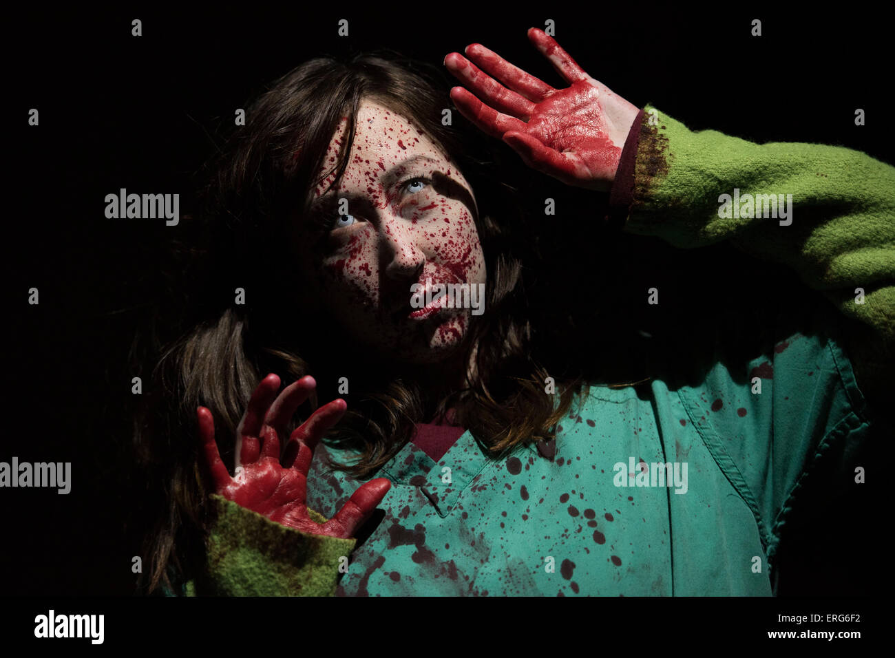 A female zombie with face splattered with blood. Stock Photo