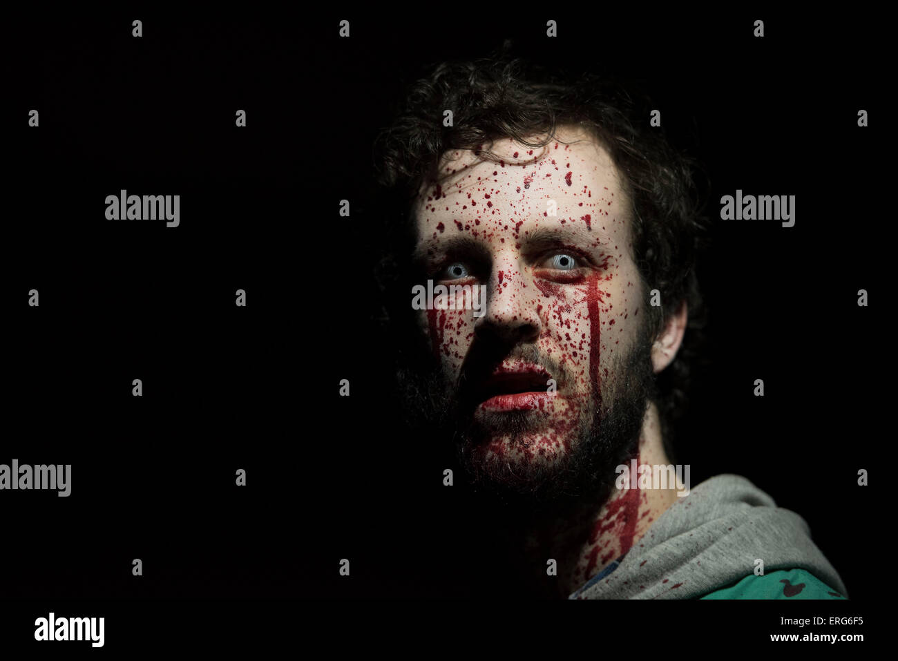 A male zombie with face splattered with blood. Stock Photo
