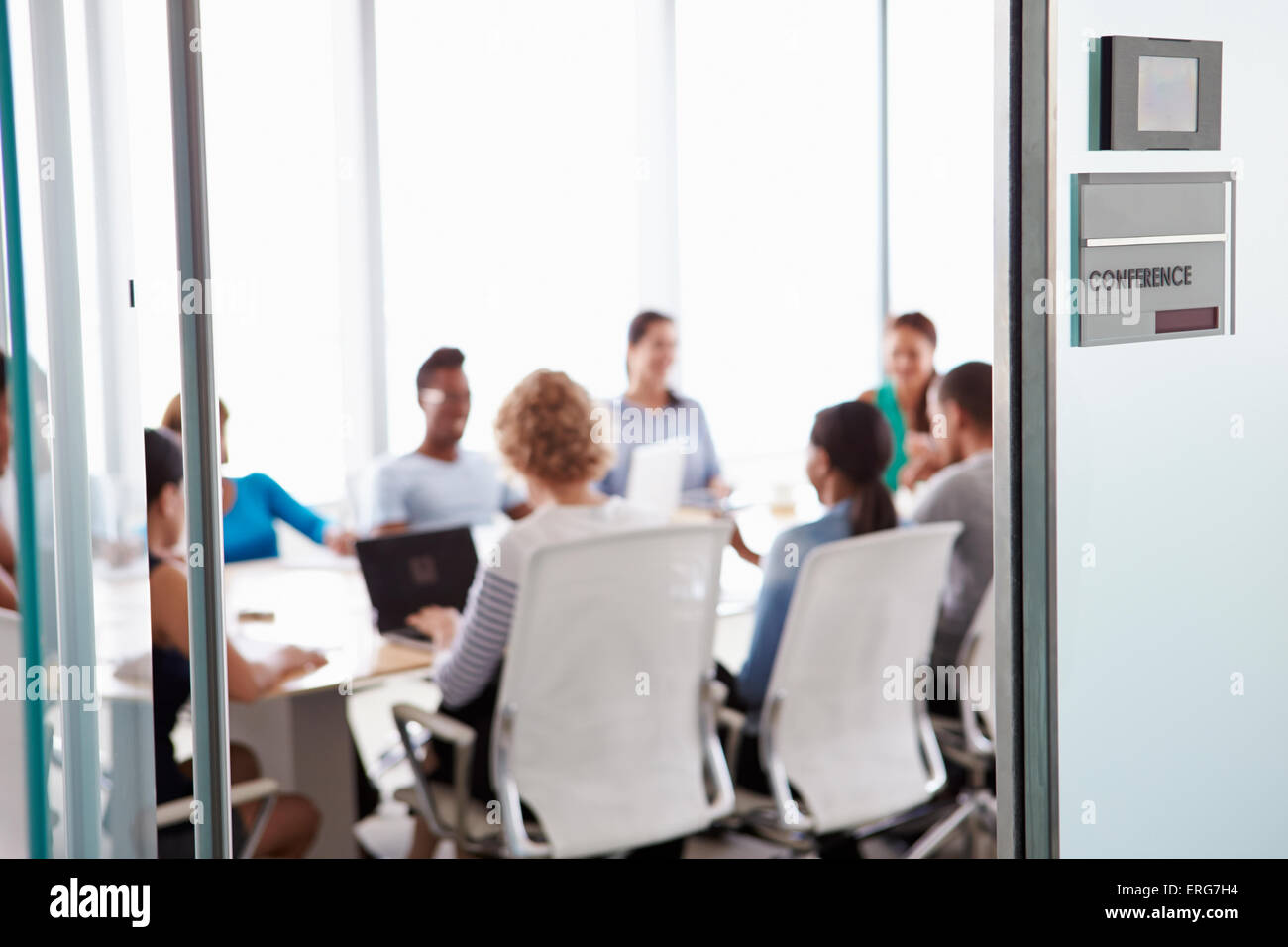 View Through Door Of Conference Room To Business Meeting Stock Photo