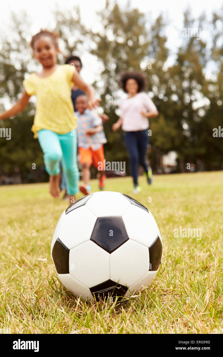 Family Playing Soccer In Park Together Stock Photo - Alamy