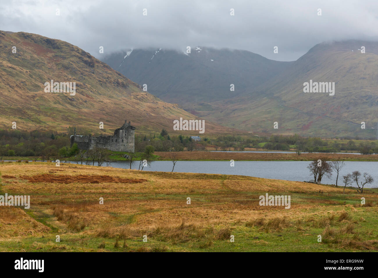 Castle Kilchurn with Loch Awe and mountain in the clouds. Stock Photo