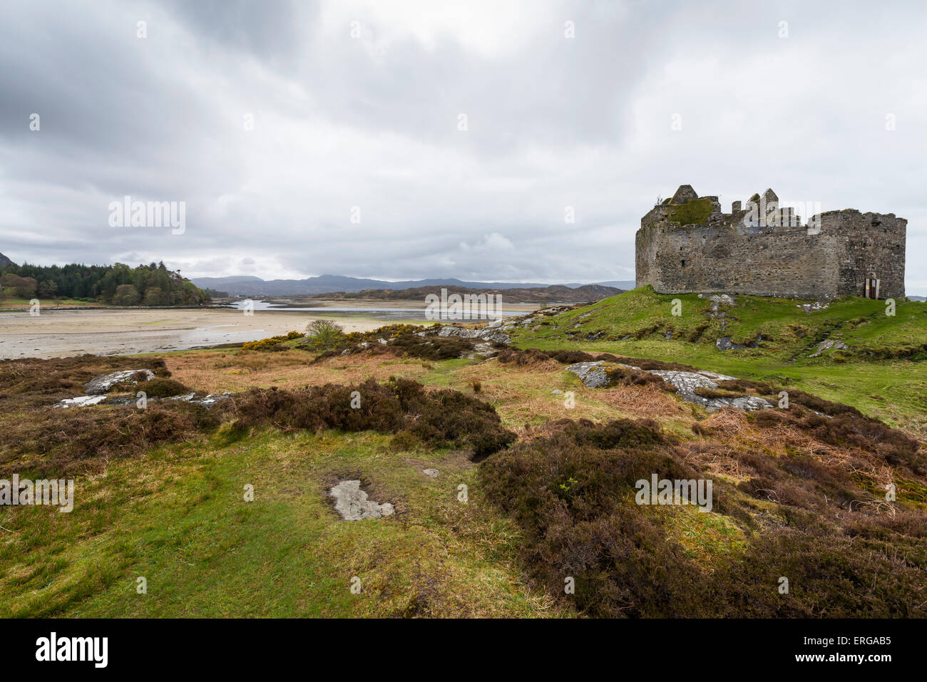Castle Tioram in the Highlands of Scotland with hills and sea. Stock Photo