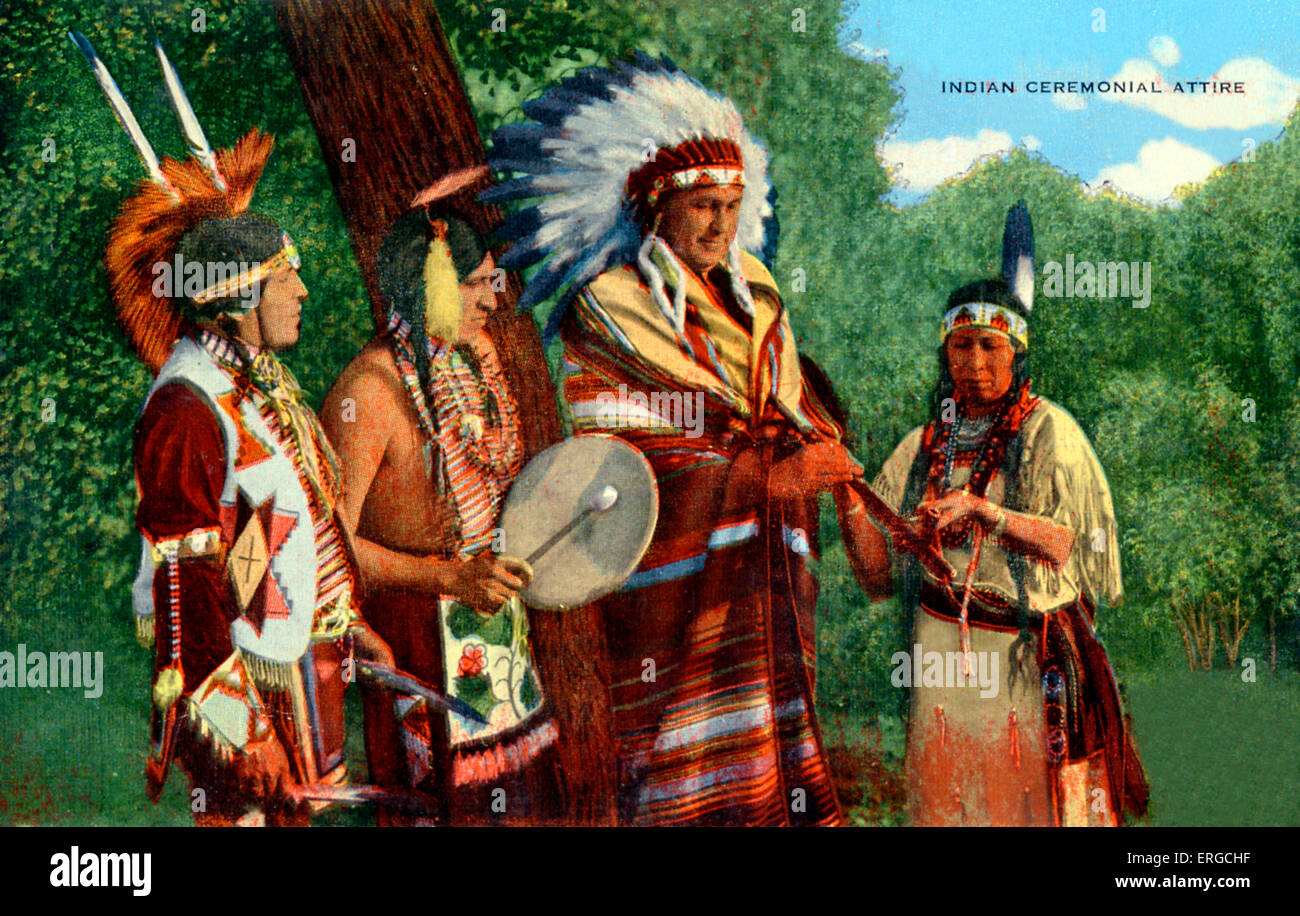 Traditional American Indian costume. Three men holding musical instruments, and one woman. Caption reads: 'Indian ceremonial Stock Photo